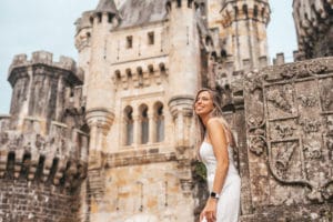 Young woman in front of a medieval castle