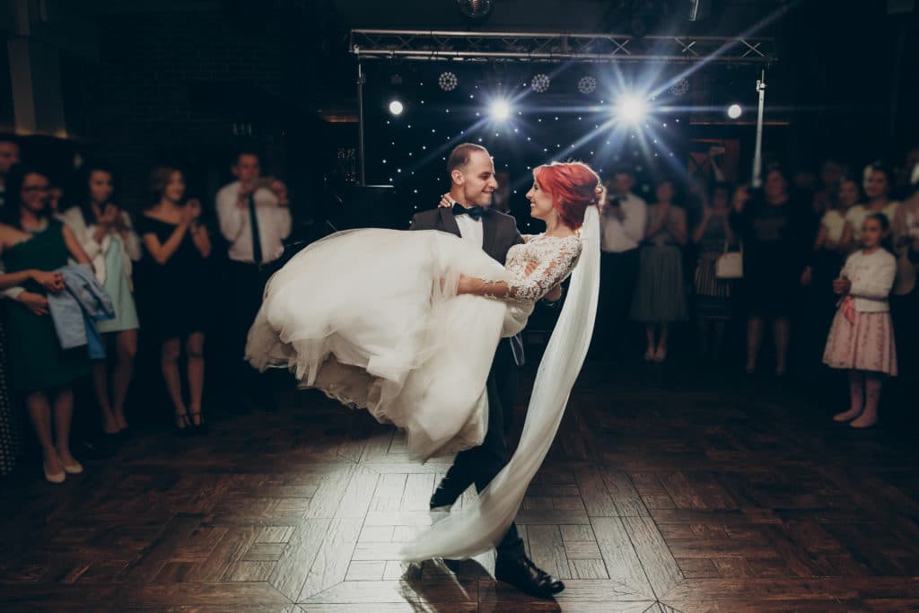 Gorgeous wedding couple performing first dance in restaurant