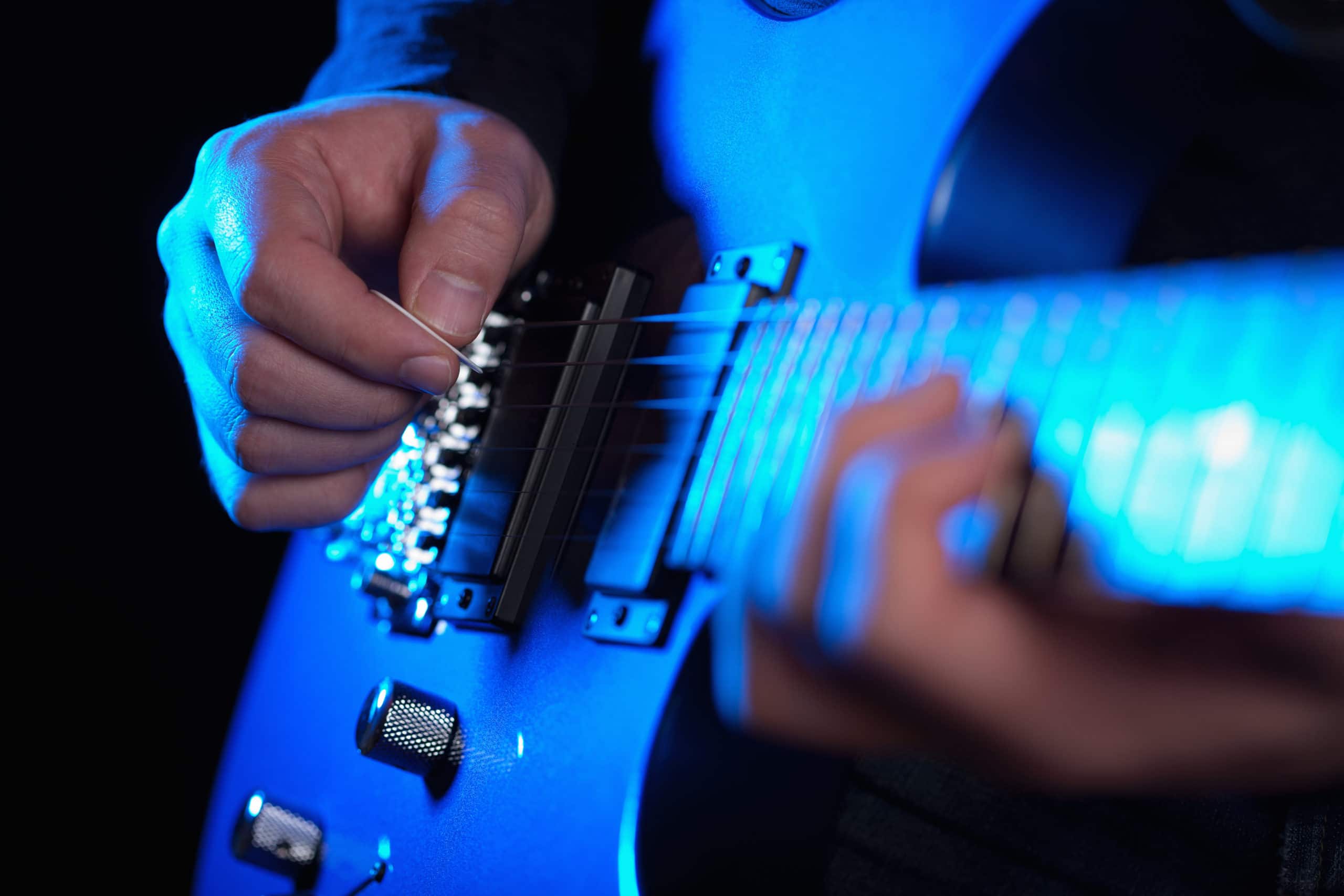 musician rock guitarist playing a blue guitar